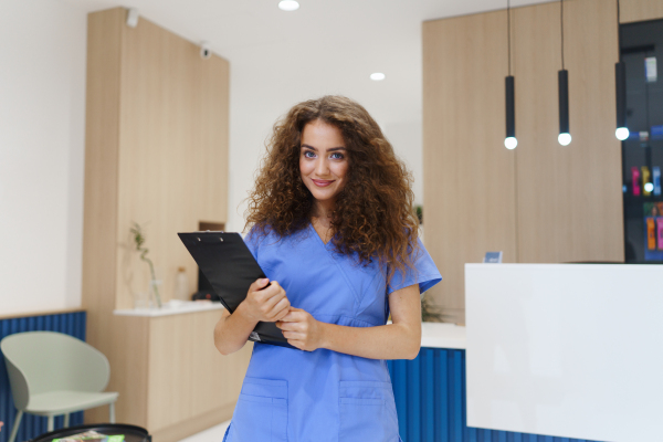 Portrait of dentist nurse posing at reception on a private dental clinic.