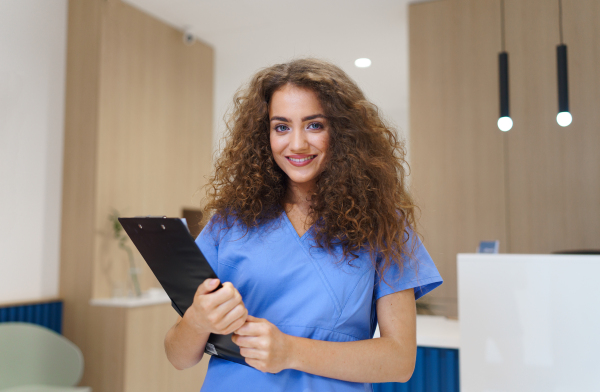 Portrait of dentist nurse posing at reception on a private dental clinic.