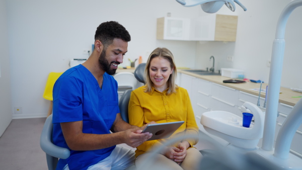 Video of dentist doing a consultation with digital tablet with his patient.