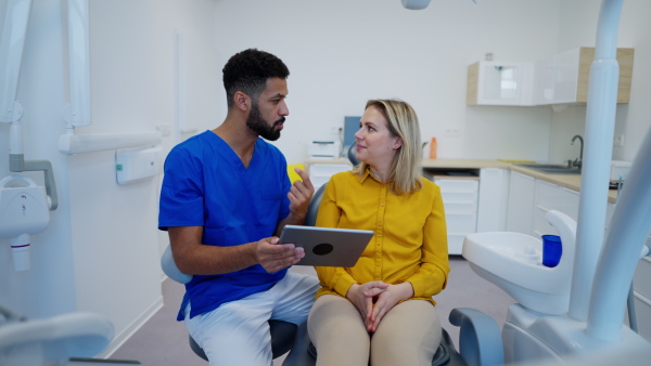 Video of dentist doing a consultation with digital tablet with his patient.