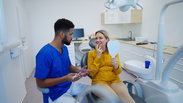 Video of dentist doing a consultation with digital tablet with his patient.