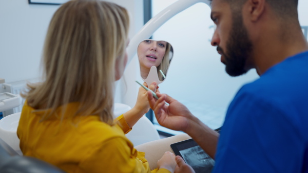 Video of dentist doing a consultation with digital tablet with his patient.