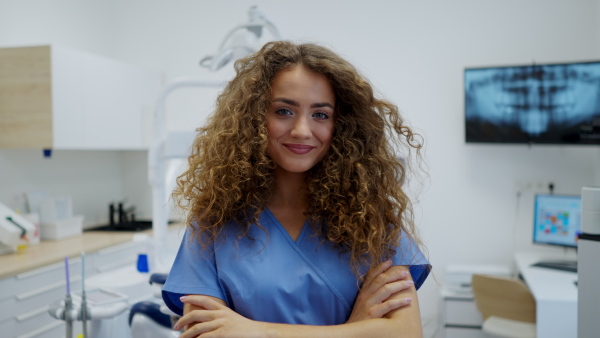 Video of dentist nurse posing at reception on a private dental clinic.