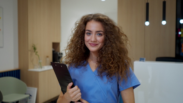 Video of dentist nurse posing at reception on a private dental clinic.