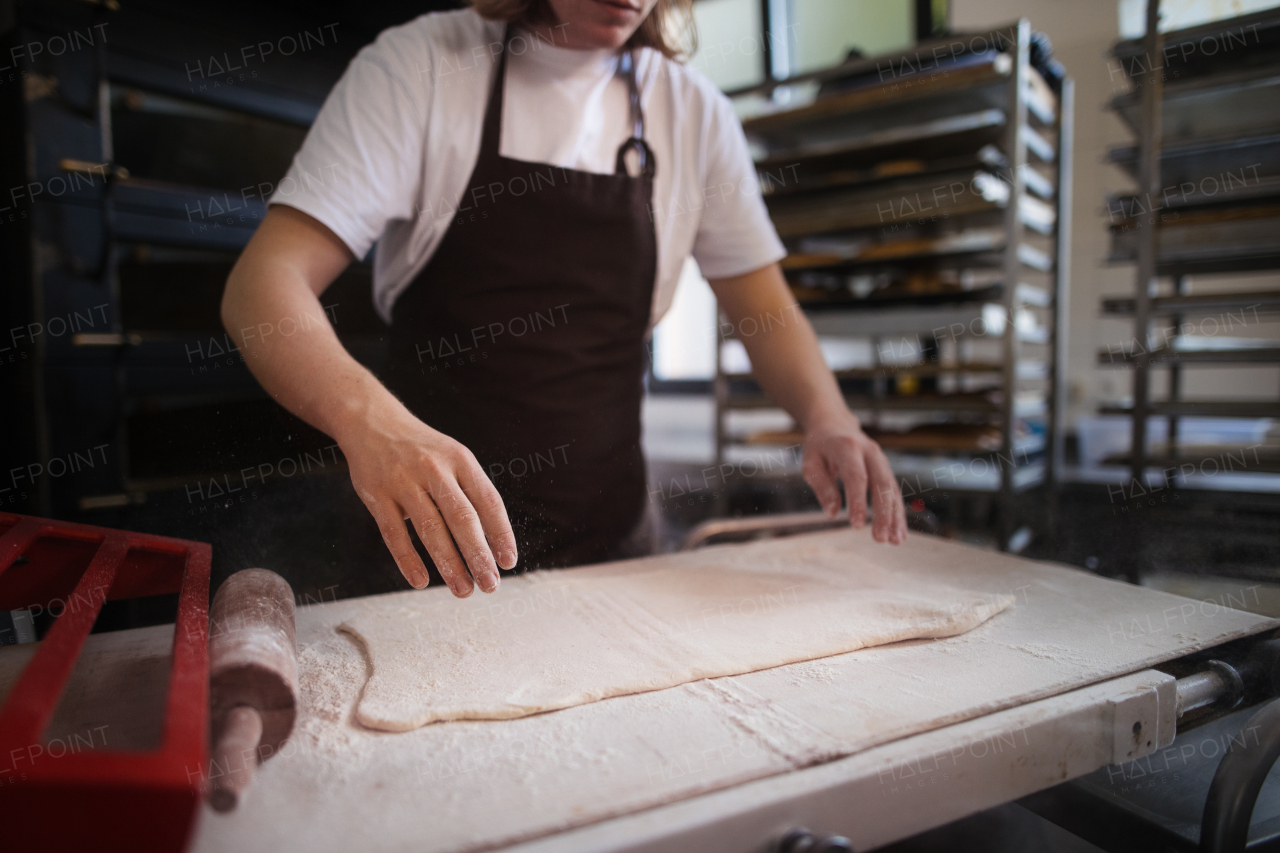 Close-up of baker preparing pastries in a bakery.