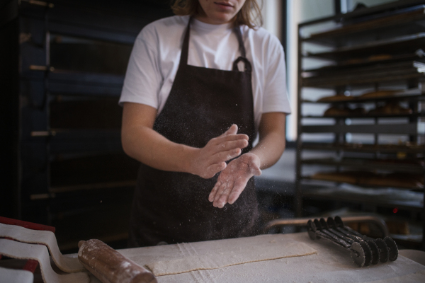 Close-up of baker preparing pastries in a bakery.