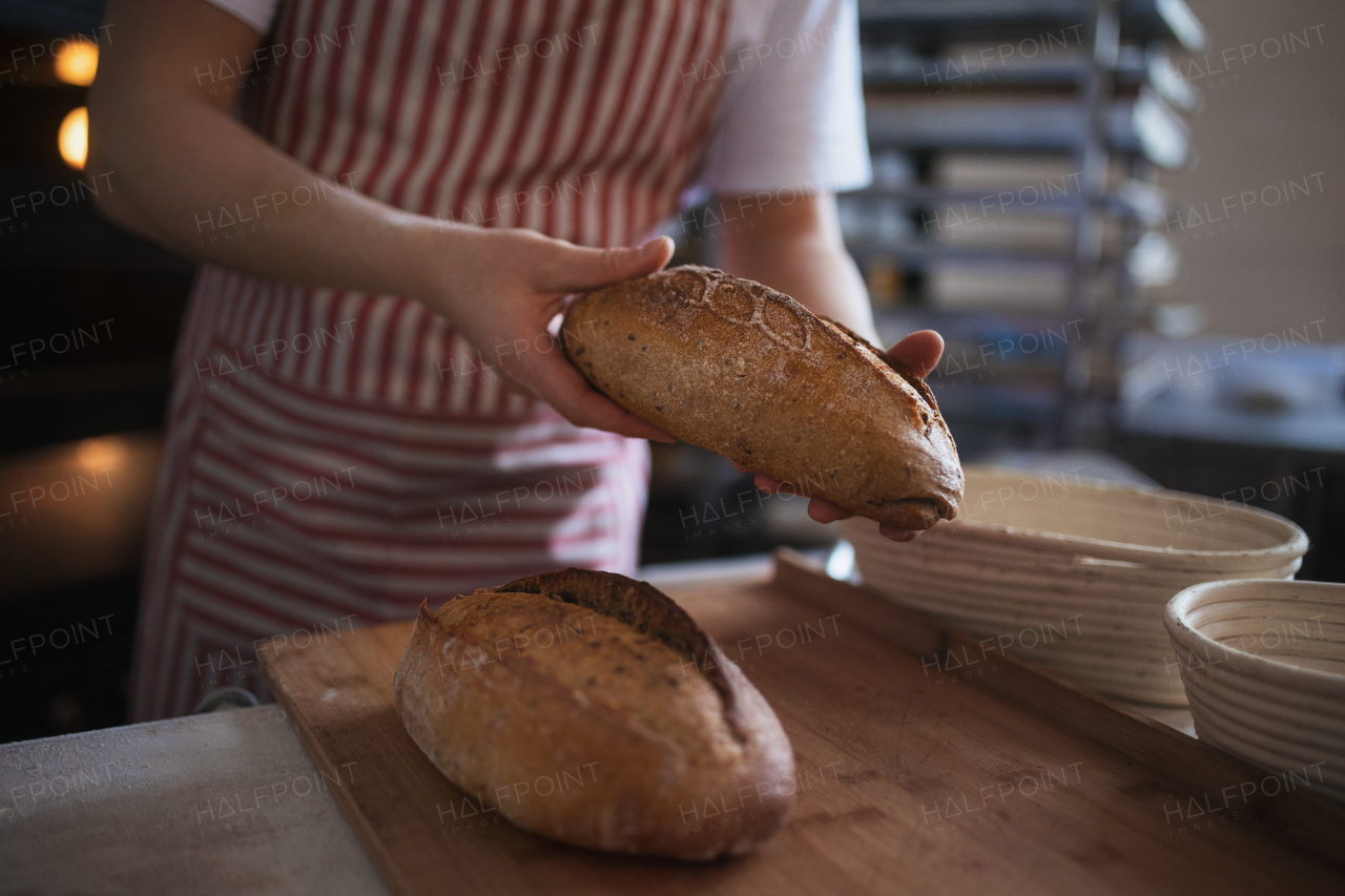 Close-up of baker with fresh just baked bread.