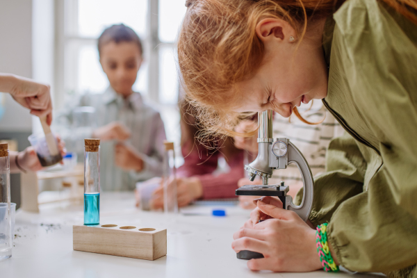 Children doing a chemistry experiment during science education.