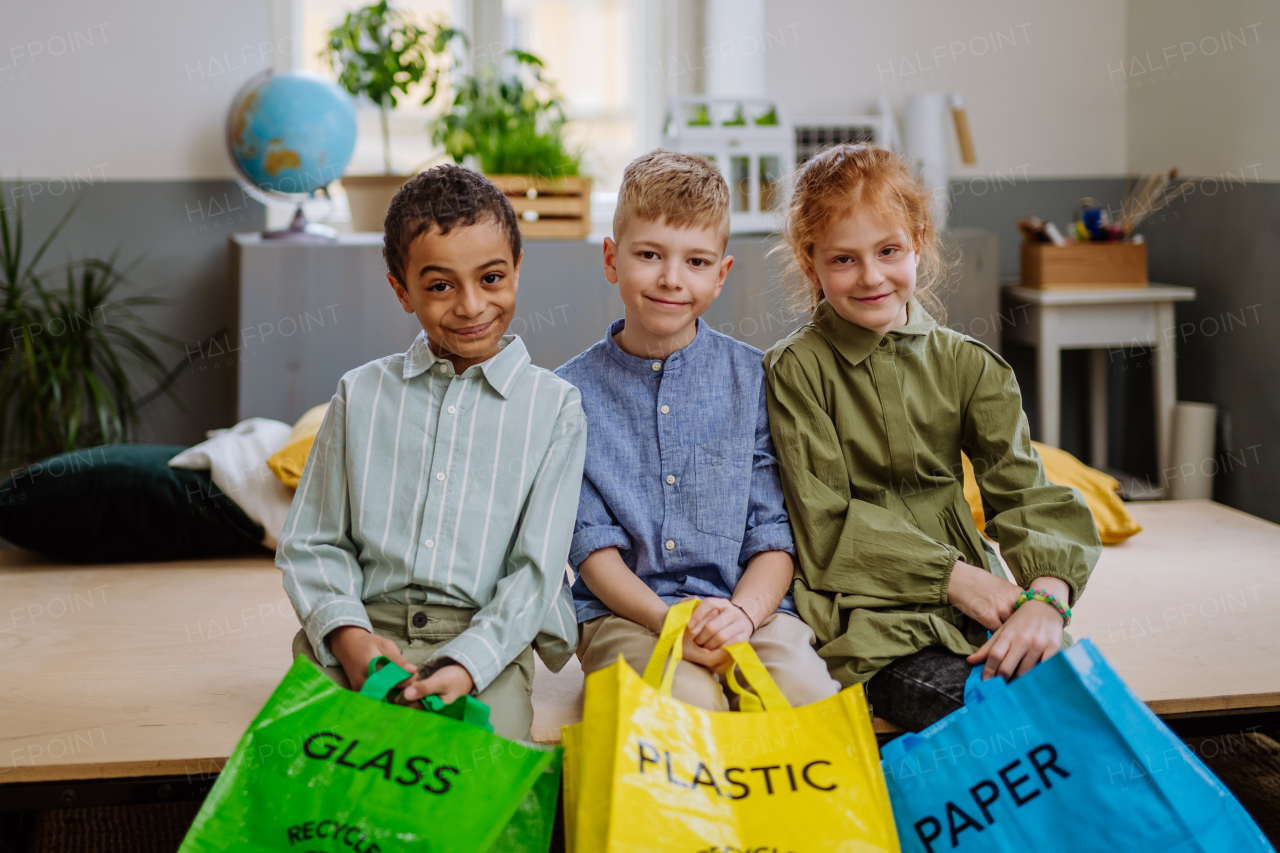 Children separating rubish in to a bins.