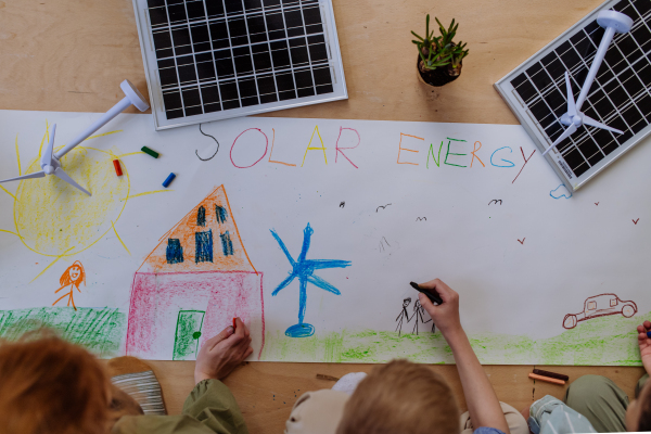 Children drawing a project to environmental lesson in school.