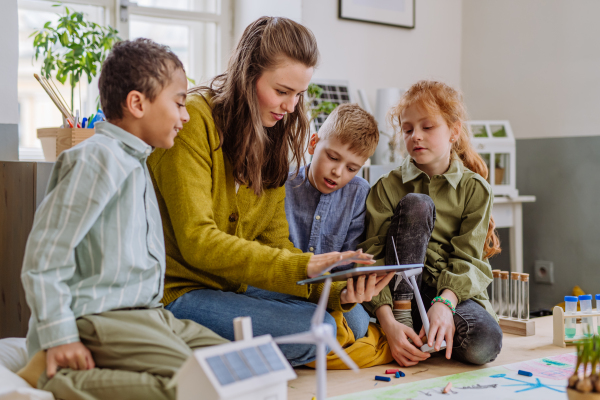 Young teacher learning her pupils about solar and wind energy.