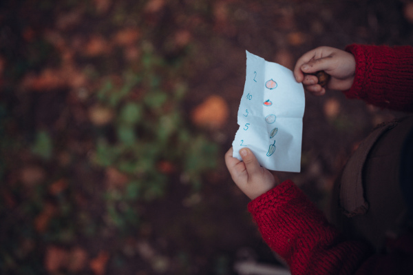 Close-up of little girl holding draw shopping list, game, children motivation and childhood concept.