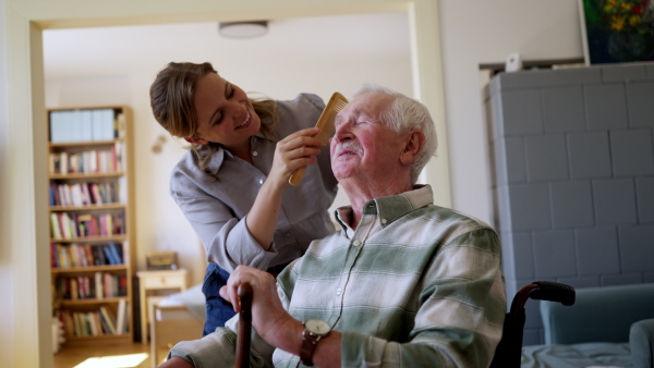 Video of daughter visiting her senior father and taking care of him.