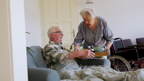 Video of senior couple at home. Senior woman taking care of her sick husband.