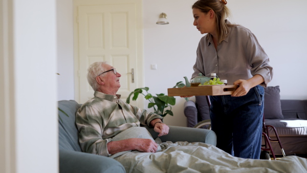 Video of daughter visiting her senior father and taking care of him.