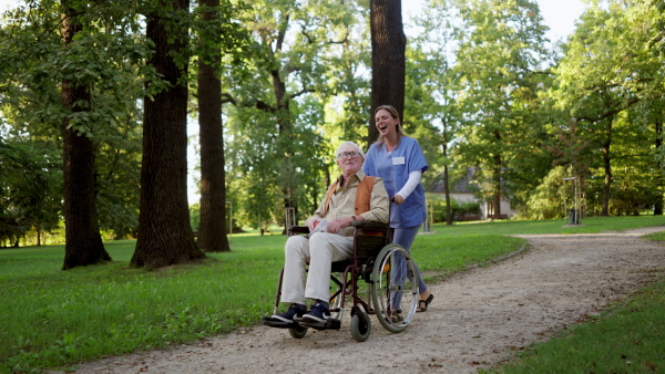 Video of a nurse on a walk in a public park with one of the disabled patients.