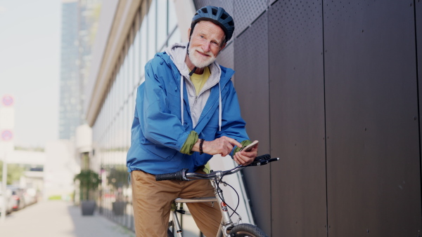 An elderly man, cyclist traveling through the city by bike. Senior city commuter riding a bike to grocery store.