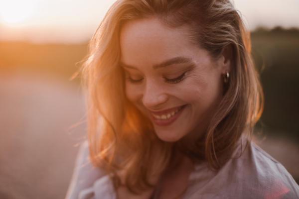 Portrait of a beautiful woman outdoor during sunset.