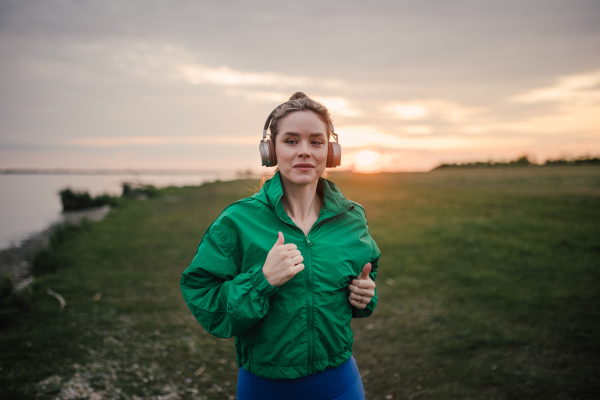 Young woman runing outdoor, near a lake.