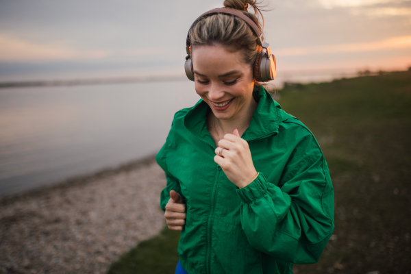 Young woman runing outdoor, near a lake.