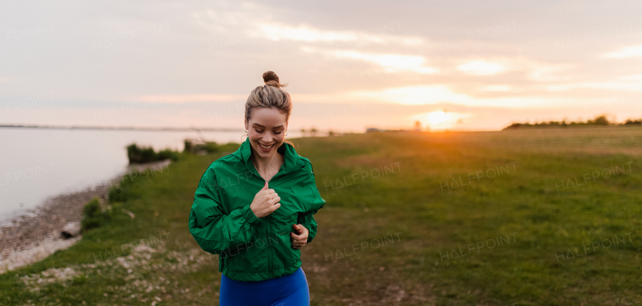 Young woman runing outdoor, near a lake.