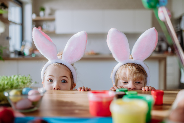 Little siblings enjoying easter time together in their home.