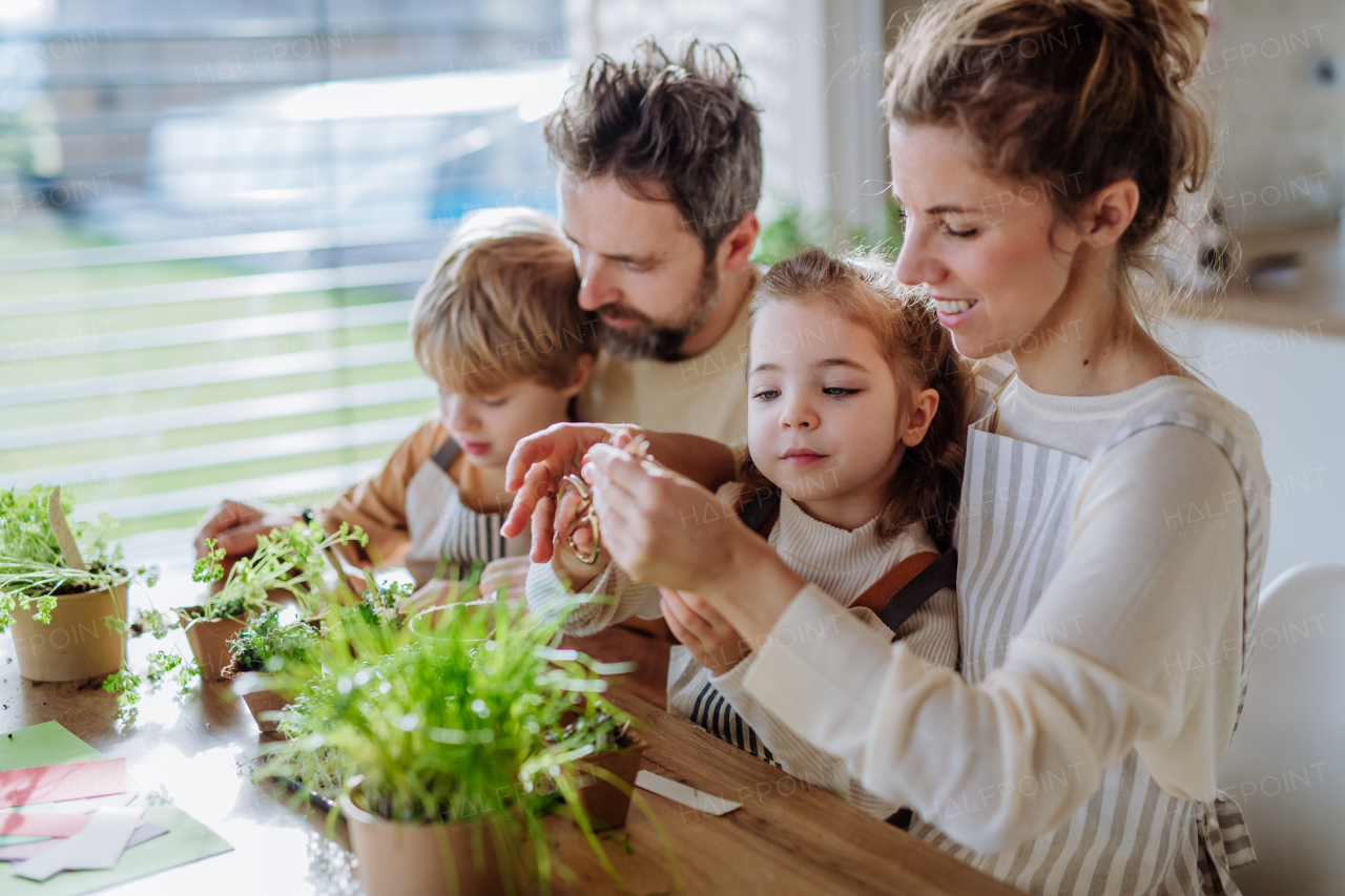 Happy family planting herbs together during spring.