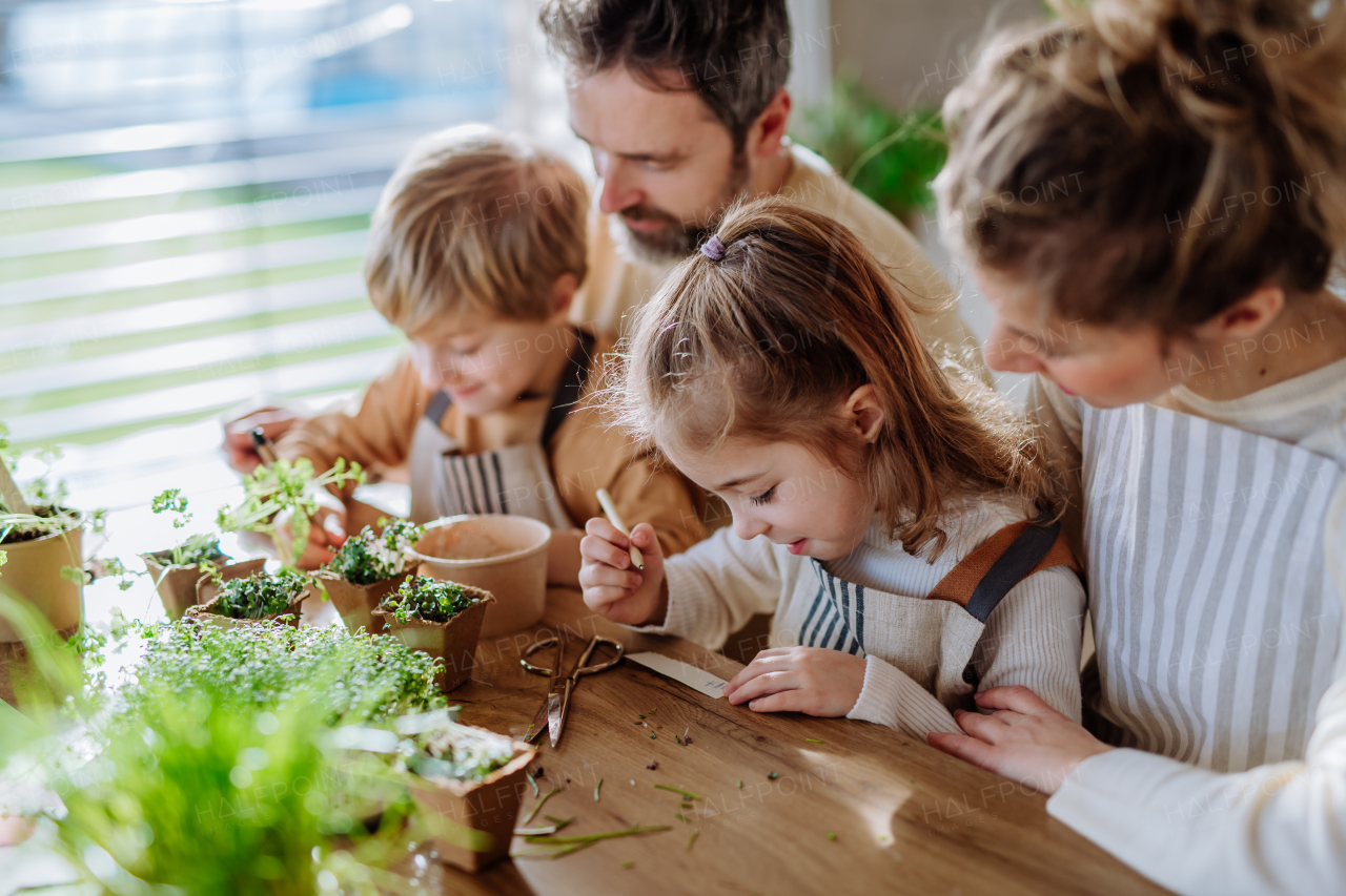 Happy family planting herbs together during spring.