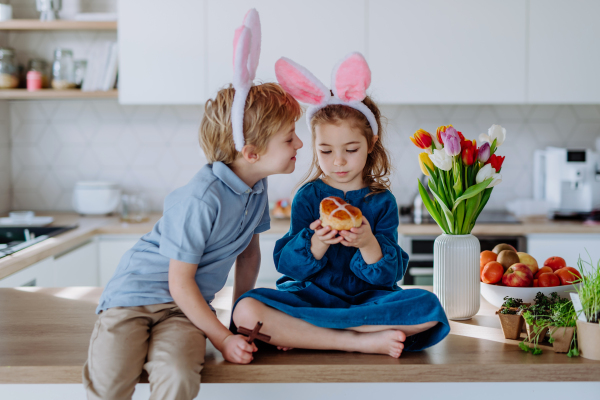 Little siblings enjoying easter time together in their home.