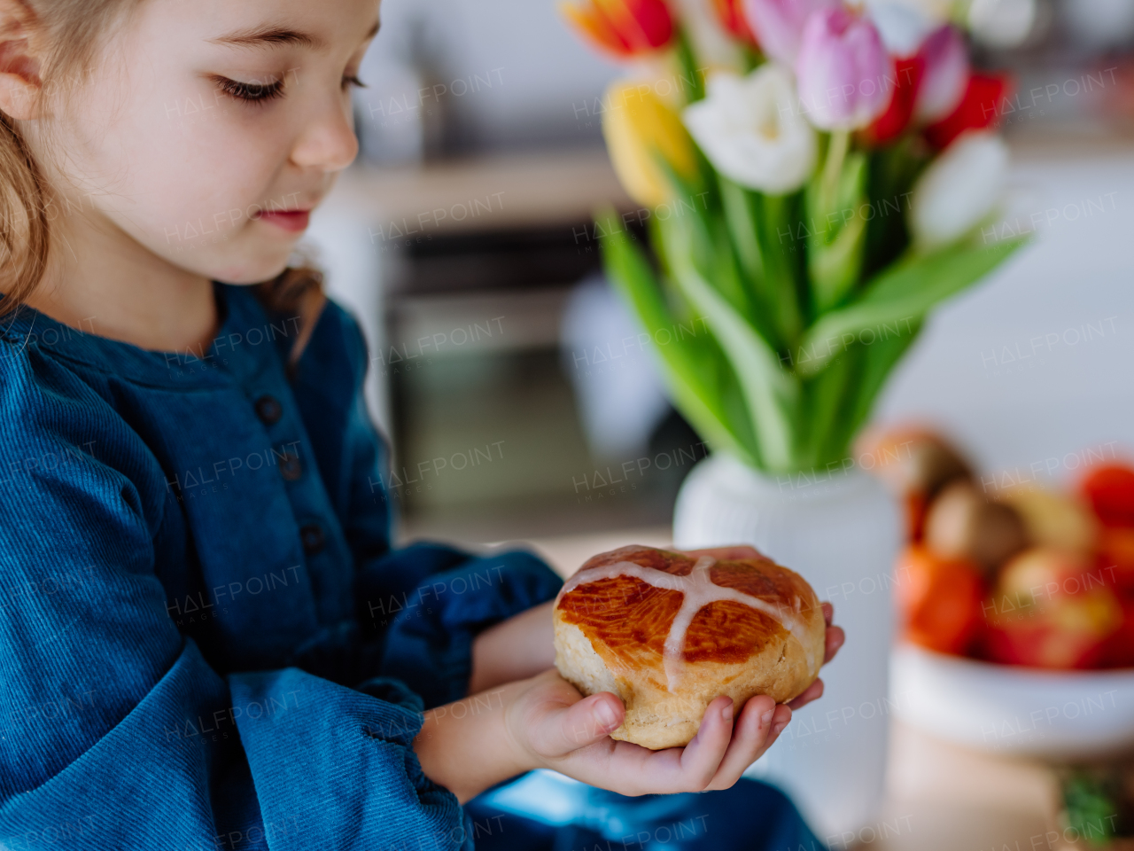 Little girl holding an easter pastries, celebrating easter and spring.