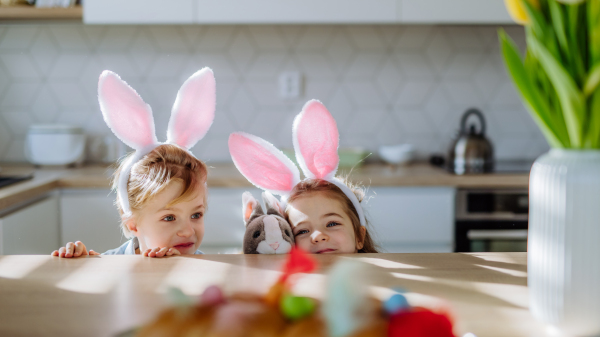 Little siblings enjoying easter time together in their home.