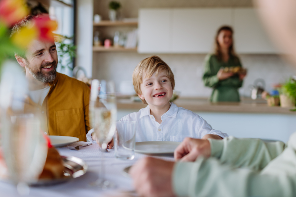 Happy young family preparing for Easter lunch together.