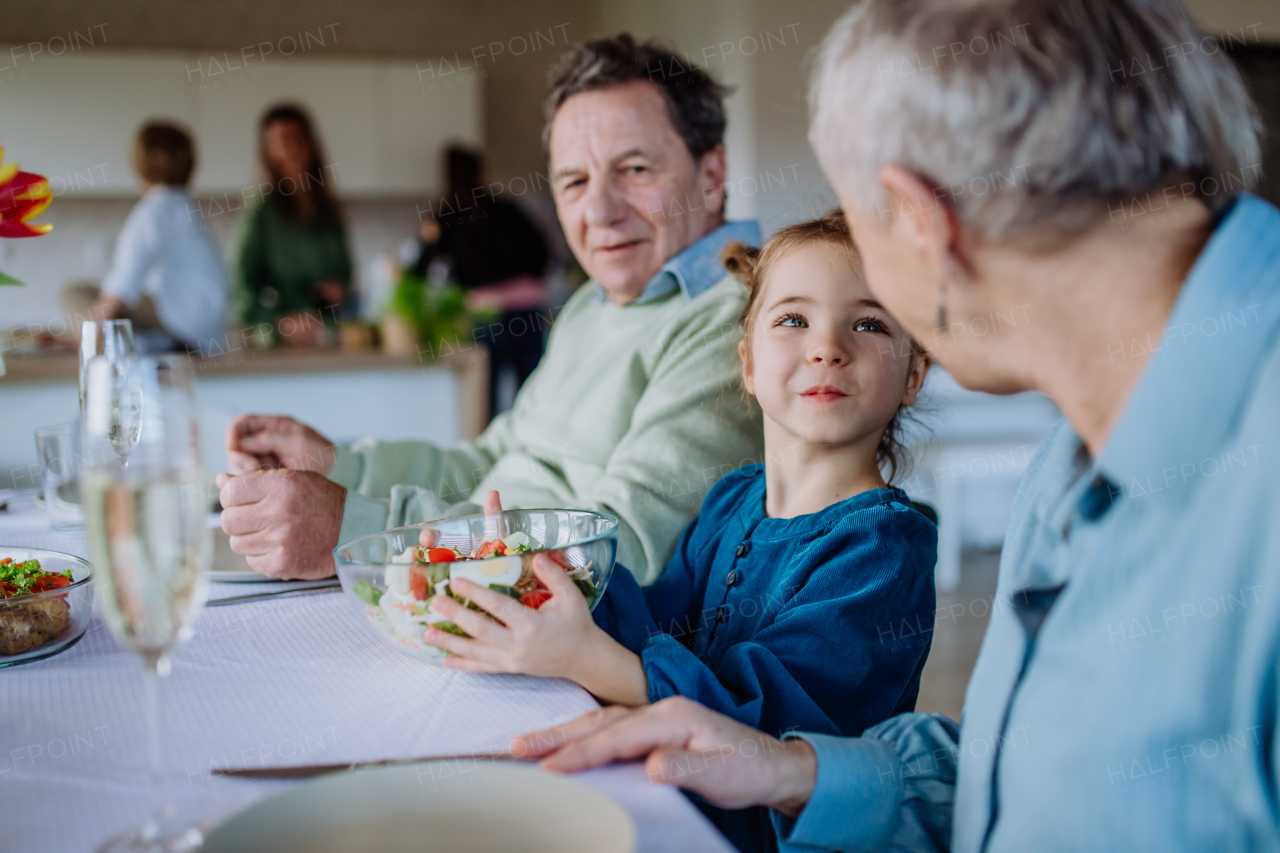 Happy multigenertional family having Easter lunch together.