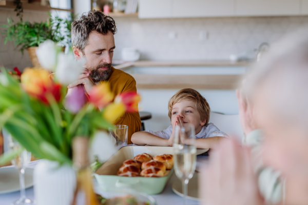 Close-up of family praying before Easter dinner.