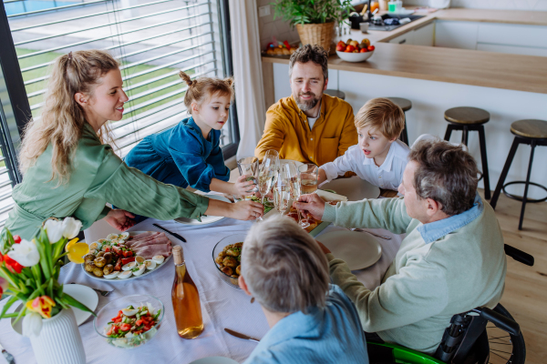 Happy family toasting before an Easter dinner.