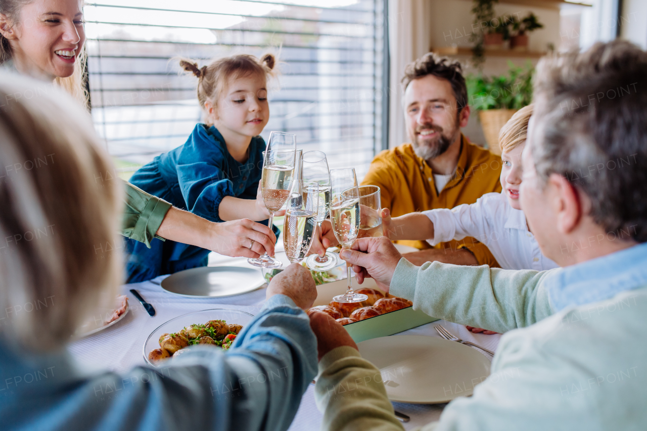 Happy family toasting before an Easter dinner.