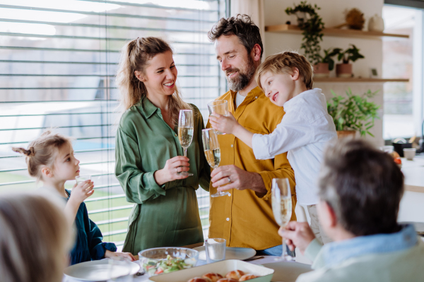 Happy family toasting before an Easter dinner.