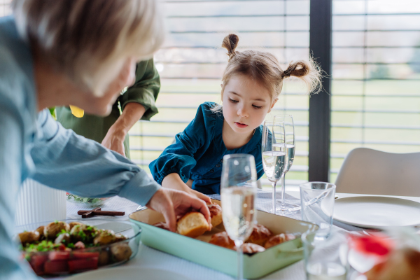 Happy multigenertional family having Easter lunch together.