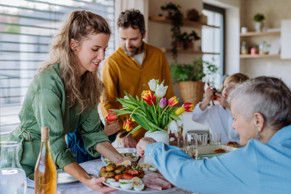 Happy multigenertional family having Easter lunch together.