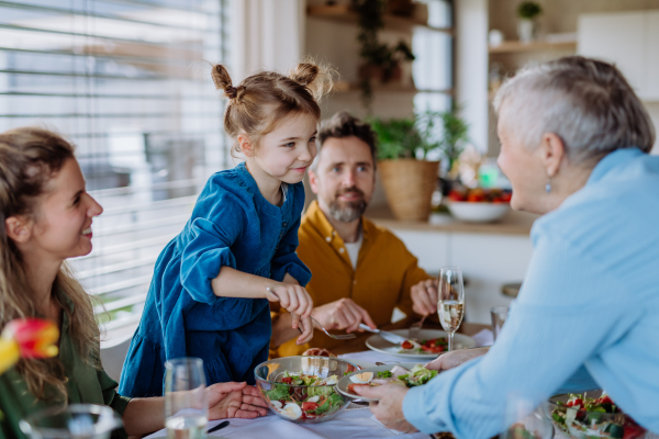 Happy multigenertional family having Easter lunch together.