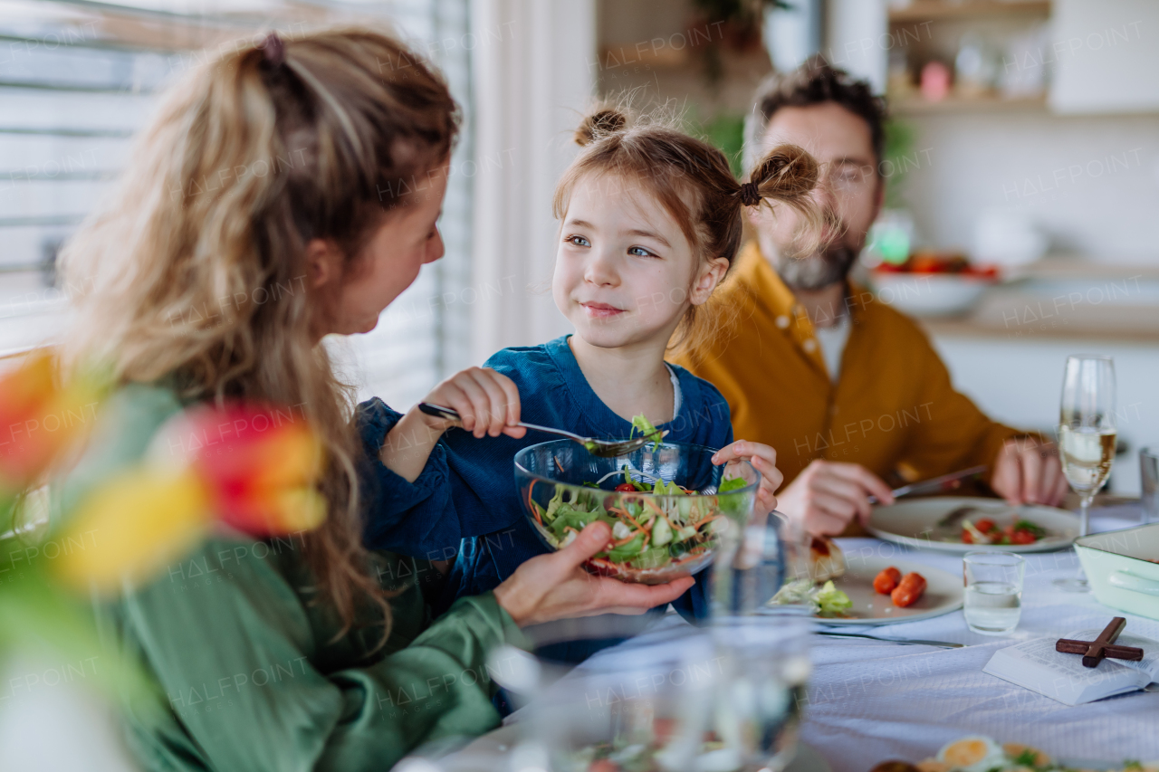 Happy family having Easter lunch together in home.