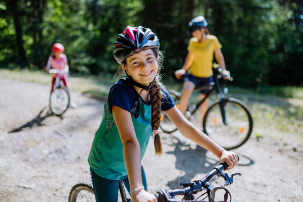 Young family with little children at a bike trip together in nature.