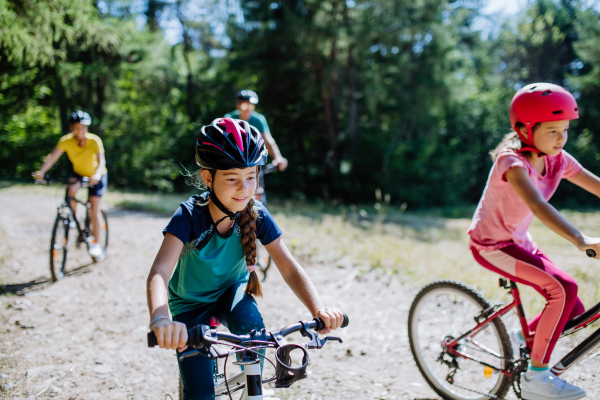 Young family with little children at a bike trip together in nature.