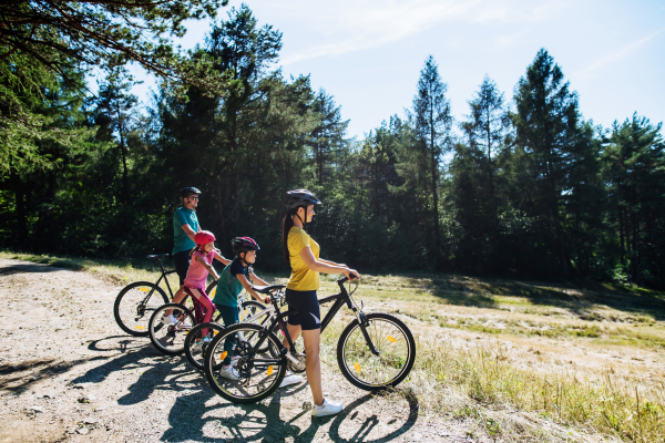 Young family with little children at a bike trip together in nature.