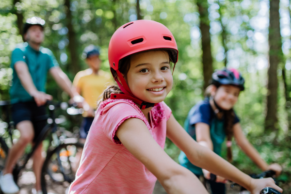 Young family with little children at a bike trip together in nature.