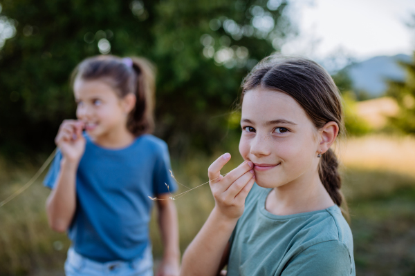 Portrait of a happy little girls chilling and enjoying summer nature together.