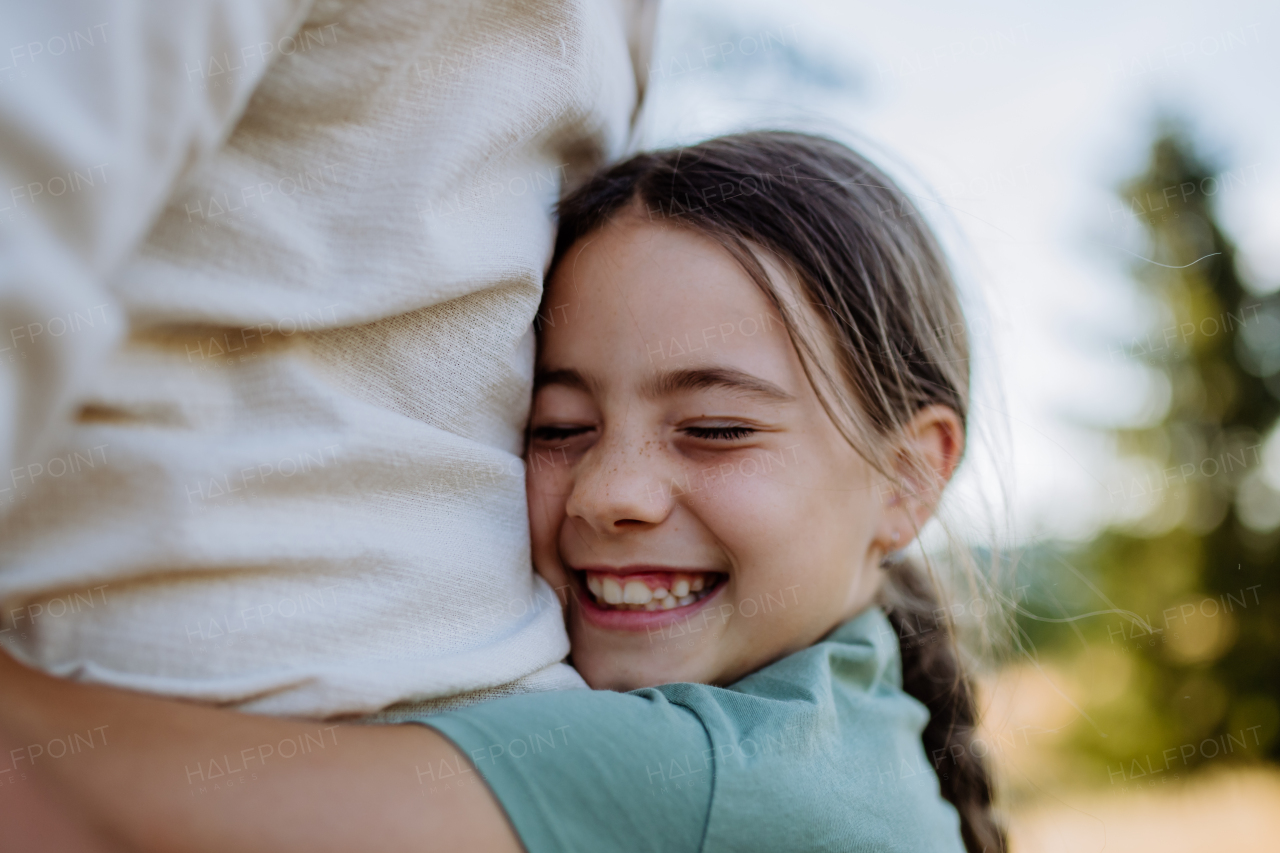 A little girl hugging her father, close up. Father's day concept.