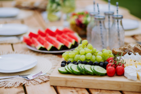 A dining table set for dinner on the terrace in summer, garden party concept.