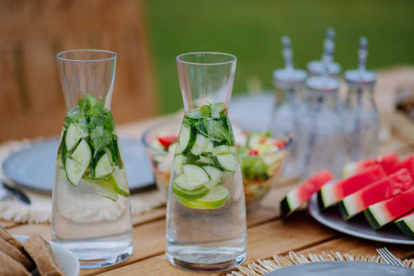 Cold refreshing summer drinks and fruit set on a table at garden.