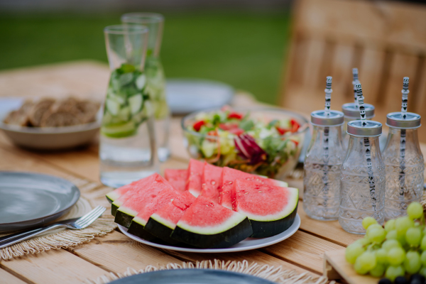 A dining table set for dinner on the terrace in summer, garden party concept.